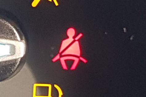 Warning light that looks like a person with a seatbelt on.